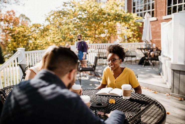 Two students drink coffee outdoors on Asbury University's campus